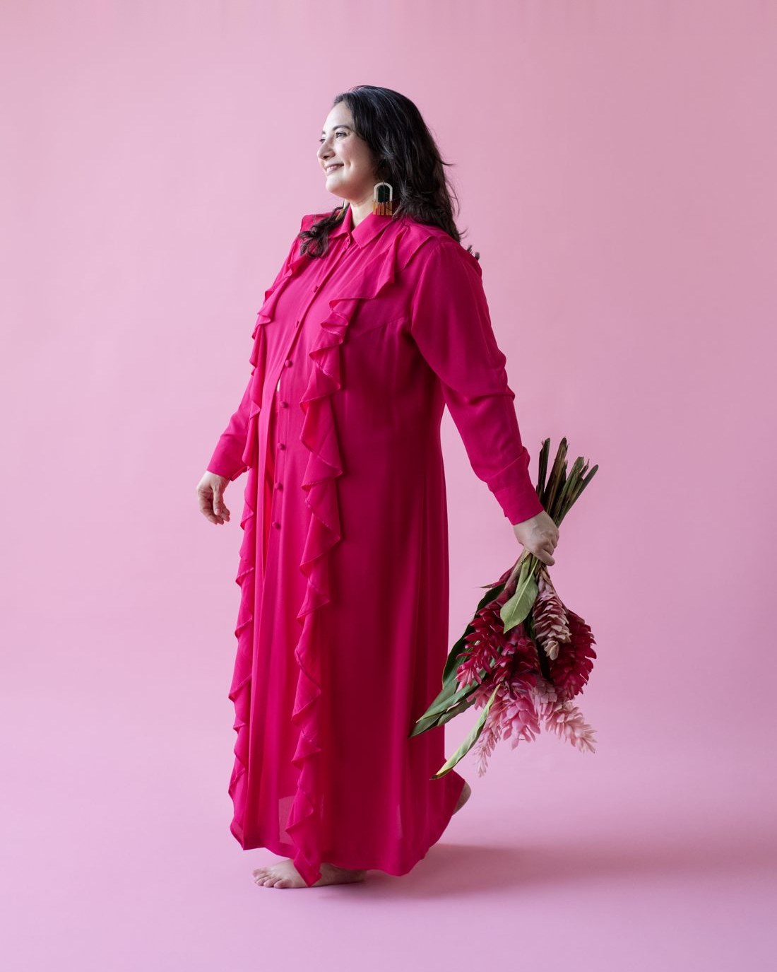 Alejandra Porta in a pink dress holding flowers